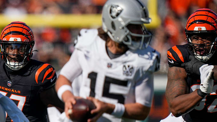 Cincinnati Bengals linebacker Germaine Pratt (57) and defensive tackle B.J. Hill (92) pursue Las Vegas Raiders quarterback Gardner Minshew (15) in the first quarter of the NFL Week 9 game between the Cincinnati Bengals and the Las Vegas Raiders at Paycor Stadium in downtown Cincinnati on Sunday, Nov. 3, 2024.