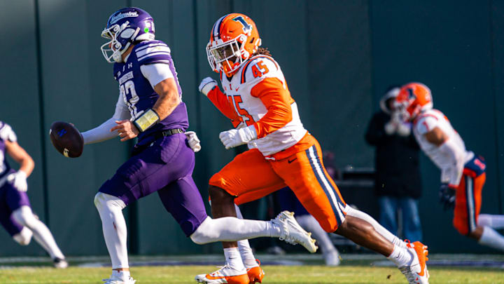 Illinois linebacker Malachi Hood (45) chases down Northwestern quarterback Jack Lausch (12) in the Illini's 38-38 win over the Wildcats at Chicago's Wrigley Field on Nov. 30, 2024.