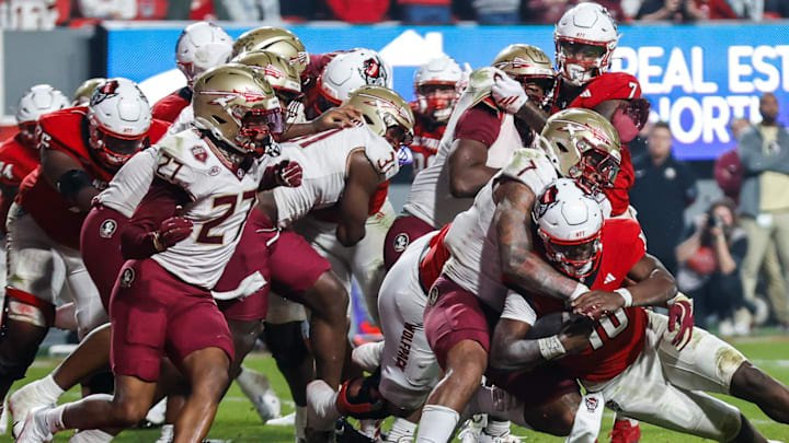 Nov 21, 2025; Raleigh, North Carolina, USA; Florida State Seminoles linebacker Stefon Thompson (7) tackles NC State Wolfpack quarterback Will Wilson (10) during the second half of the game at Carter-Finley Stadium. Mandatory Credit: Jaylynn Nash-Imagn Images