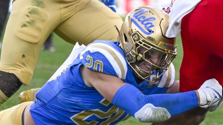 Nov 30, 2024; Pasadena, California, USA; UCLA Bruins linebacker Kain Medrano (20) tries to bring down Fresno State Bulldogs running back Bryson Donelson (26) during the third quarter at Rose Bowl. Mandatory Credit: Robert Hanashiro-Imagn Images