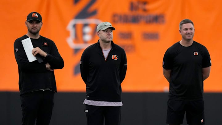From left: Director of College Scouting Mike Potts, Director of Player Personnel Duke Tobin, head coach Zac Taylor and defensive coordinator Lou Anarumo talk as rookies stretch during the team   s mini rookie camp, Friday, May 12, 2023, inside the team   s indoor practice bubble in Cincinnati.