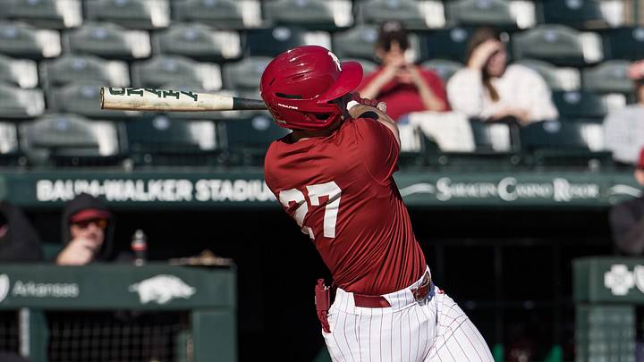Feb 6, 2026; Fayetteville, AR, USA;  Arkansas Razorbacks catcher Ryder Helfrick (27) hits a double during the third inning of the Arkansas Razorbacks scrimmage at Baum-Walker Stadium. Mandatory Credit: Brett Rojo-Imagn Images