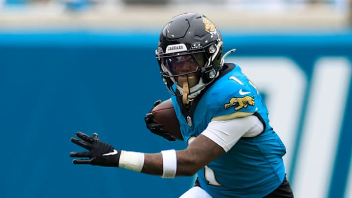 Jacksonville Jaguars running back Travis Etienne Jr. (1) is tripped up by Indianapolis Colts linebacker E.J. Speed (45) during the first quarter of an NFL football matchup Sunday, Oct. 6, 2024 at EverBank Stadium in Jacksonville, Fla. The Jaguars edged the Colts on a field goal 37-34. [Corey Perrine/Florida Times-Union]