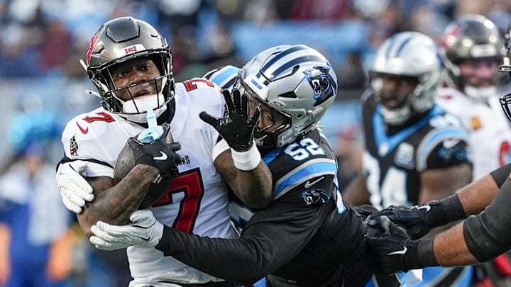 Dec 1, 2024; Charlotte, North Carolina, USA; Tampa Bay Buccaneers running back Bucky Irving (7) is tackled by Carolina Panthers linebacker DJ Johnson (52) during the first quarter at Bank of America Stadium. Mandatory Credit: Jim Dedmon-Imagn Images Dec 1, 2024; Charlotte, North Carolina, USA; Tampa Bay Buccaneers running back Bucky Irving (7) is tackled by Carolina Panthers linebacker DJ Johnson (52) during the first quarter at Bank of America Stadium. Mandatory Credit: Jim Dedmon-Imagn Images