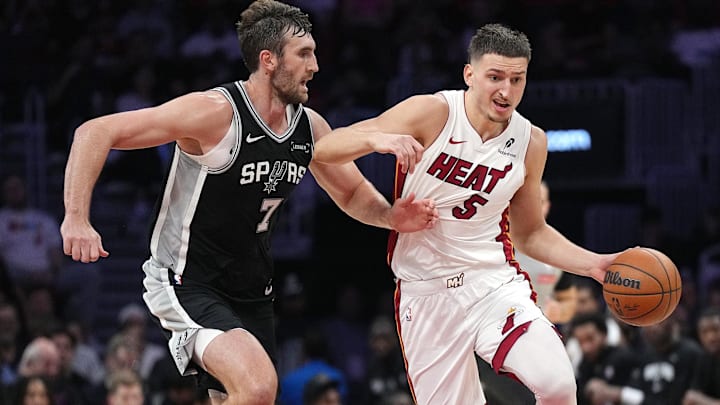 Oct 8, 2025; Miami, Florida, USA; Miami Heat forward Nikola Jovic (5) drives to the basket as San Antonio Spurs forward Luke Kornet (7) defends during the first half at Kaseya Center. Oct 8, 2025; Miami, Florida, USA; Miami Heat forward Nikola Jovic (5) drives to the basket as San Antonio Spurs forward Luke Kornet (7) defends during the first half at Kaseya Center.