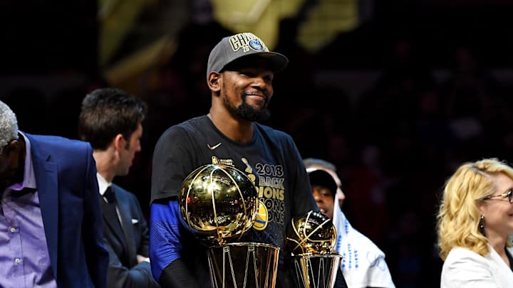 Jun 8, 2018; Cleveland, OH, USA; Golden State Warriors forward Kevin Durant (35) celebrates with the Bill Russell NBA Finals Most Valuable Player Award and the Larry O'Brien Championship Trophy after beating the Cleveland Cavaliers in game four of the 2018 NBA Finals at Quicken Loans Arena. Mandatory Credit: Kyle Terada-Imagn Images Jun 8, 2018; Cleveland, OH, USA; Golden State Warriors forward Kevin Durant (35) celebrates with the Bill Russell NBA Finals Most Valuable Player Award and the Larry O'Brien Championship Trophy after beating the Cleveland Cavaliers in game four of the 2018 NBA Finals at Quicken Loans Arena. Mandatory Credit: Kyle Terada-Imagn Images