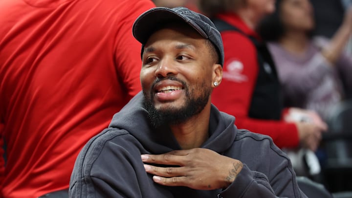 Oct 10, 2025; Portland, Oregon, USA; Portland Trail Blazers guard Damian Lillard (0) smiles while sitting on the bench before the Trail Blazers plays Sacramento Kings at Moda Center. Mandatory Credit: Jaime Valdez-Imagn Images Oct 10, 2025; Portland, Oregon, USA; Portland Trail Blazers guard Damian Lillard (0) smiles while sitting on the bench before the Trail Blazers plays Sacramento Kings at Moda Center. Mandatory Credit: Jaime Valdez-Imagn Images