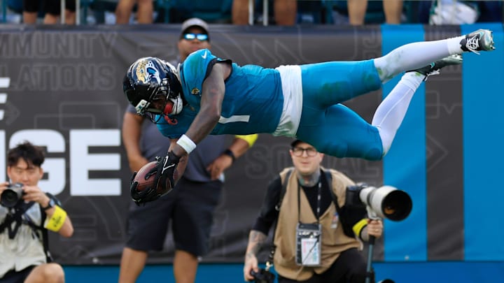 Jacksonville Jaguars RB Travis Etienne Jr. leaps to score a rushing touchdown during the fourth quarter.