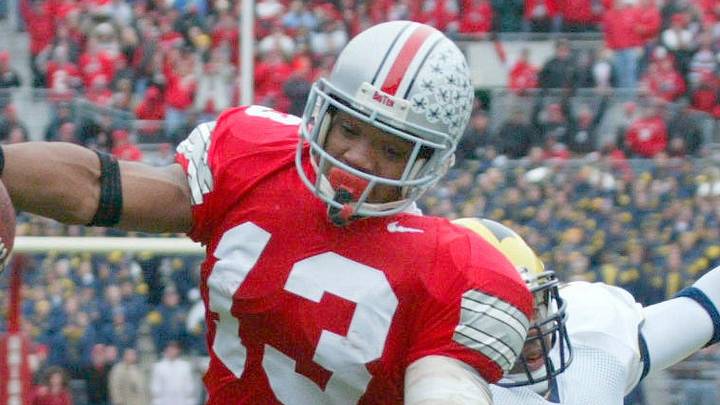 Ohio State's Maurice Clarett, 13, slips away from Michigan's Cato June, 2, to score the first touchdown of the game from two yards out in the first quarter of their game at The Ohio Stadium, November 23, 2002.