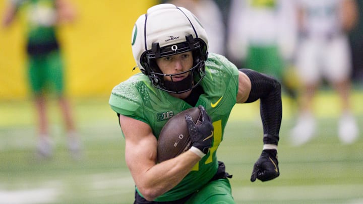 Oregon defensive back Dillon Thieneman carries the ball at practice ahead of the Peach Bowl. Oregon defensive back Dillon Thieneman carries the ball at practice ahead of the Peach Bowl.