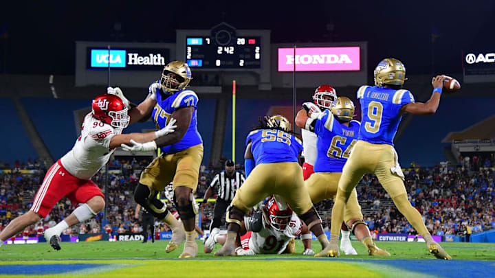 Aug 30, 2025; Pasadena, California, USA; UCLA Bruins quarterback Nico Iamaleava (9) throws as offensive lineman Courtland Ford (77) provides coverage against Utah Utes defensive end John Henry Daley (90) during the first half at Rose Bowl. Mandatory Credit: Gary A. Vasquez-Imagn Images