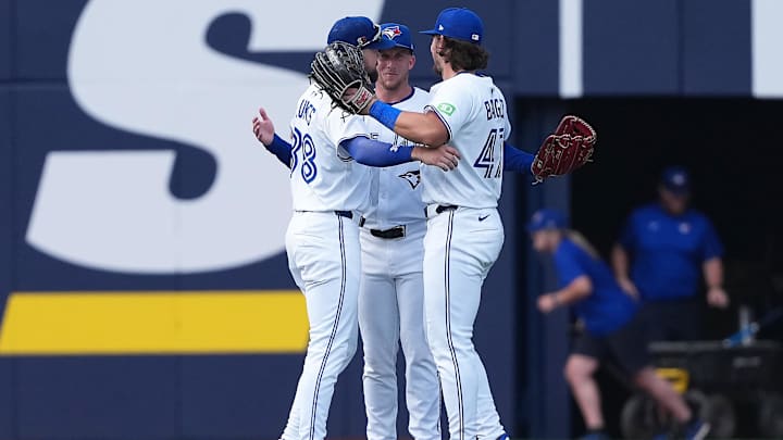 Aug 16, 2025; Toronto, Ontario, CAN; Toronto Blue Jays left fielder Nathan Lukes (38) and centre fielder Myles Straw (3) and right fielder Addison Barger (47) celebrate the win against the Texas Rangers at the end of the ninth inning at Rogers Centre. 