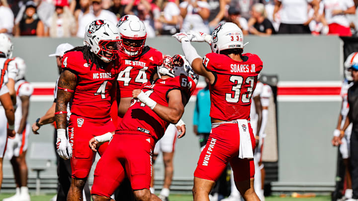Oct 4, 2025; Raleigh, North Carolina, USA; NC State Wolfpack defensive end Sabastian Harsh (54) and linebacker Jr. Kenny Soares (33) celebrate a tackle during the first half of the game against Campbell Fighting Camels at Carter-Finley Stadium. Mandatory Credit: Jaylynn Nash-Imagn Images Oct 4, 2025; Raleigh, North Carolina, USA; NC State Wolfpack defensive end Sabastian Harsh (54) and linebacker Jr. Kenny Soares (33) celebrate a tackle during the first half of the game against Campbell Fighting Camels at Carter-Finley Stadium. Mandatory Credit: Jaylynn Nash-Imagn Images
