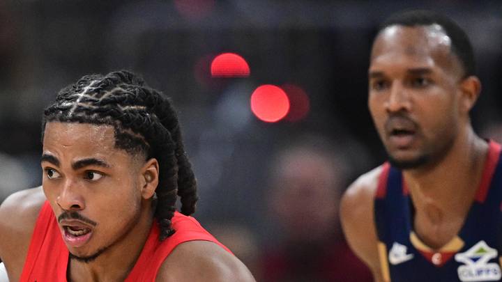 Toronto Raptors forward Collin Murray-Boyles dribbles ahead of Cleveland Cavaliers center Evan Mobley.