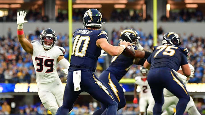 Justin Herbert drops back to pass vs Texans. Justin Herbert drops back to pass vs Texans.