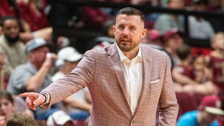 Florida State Seminoles head coach Luke Loucks signals to a player from the sideline. The Florida State Seminoles hosted the Southern Methodist University Mustangs at the Tucker Civic Center on Saturday, March 7, 2026.