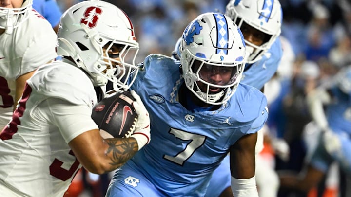 Stanford Cardinal running back Cole Tabb (33) with the ball as North Carolina Tar Heels linebacker Khmori House (7) defends in the third quarter at Kenan Stadium.