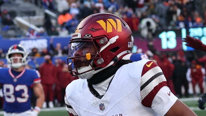 Washington Commanders wide receiver Jaylin Lane runs the ball for a punt return touchdown.