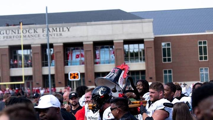 Cincinnati Bearcats carry off the victory bell after defeating the Miami Redhawks at Yager Stadium in Cincinnati on Saturday, Sept. 14, 2024.