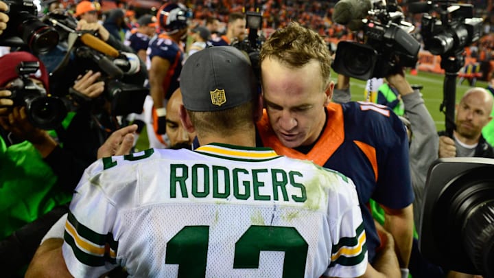 Former Denver Broncos quarterback Peyton Manning hugs Green Bay Packers quarterback Aaron Rodgers after a game in 2015.