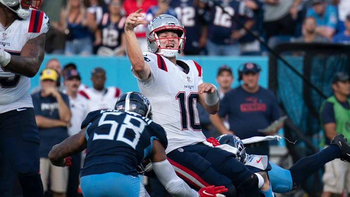 New England Patriots quarterback Drake Maye (10) throws while in the grasp of Tennessee Titans safety Mike Brown (44) during their game at Nissan Stadium in Nashville, Tenn., Sunday, Nov. 3, 2024. It was the last play of regulation and the New England Patriots running back Rhamondre Stevenson (38) came up with the reception in the end zone to force overtime. The play lasted more than 11 seconds as Mayes kept the play alive under constant pressure.