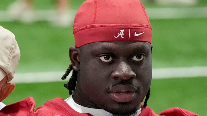 Aug. 4, 2025; Tuscaloosa, AL, USA; Alabama Crimson Tide players and coaches participate in a media day with reporters and fans at the Hank Crisp Indoor Practice Facility. Fan Mike Bailey leans in close to talk two quarterback Ty Simpson and running back Richard Young.