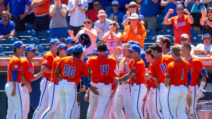 Florida Gators slugger Jac Caglianone is mobbed by teammates after a home run. Florida Gators slugger Jac Caglianone is mobbed by teammates after a home run.