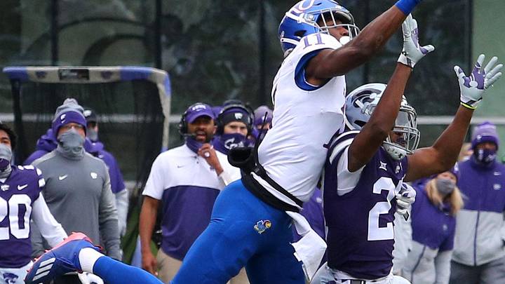 Kansas State Wildcats DB Aamaris Brown (21) breaks up a pass intended for Kansas Jayhawks WR Ezra Naylor II (11)
