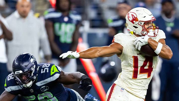 Arizona Cardinals wide receiver Michael Wilson against diving Seattle Seahawks linebacker Derick Hall Arizona Cardinals wide receiver Michael Wilson against diving Seattle Seahawks linebacker Derick Hall