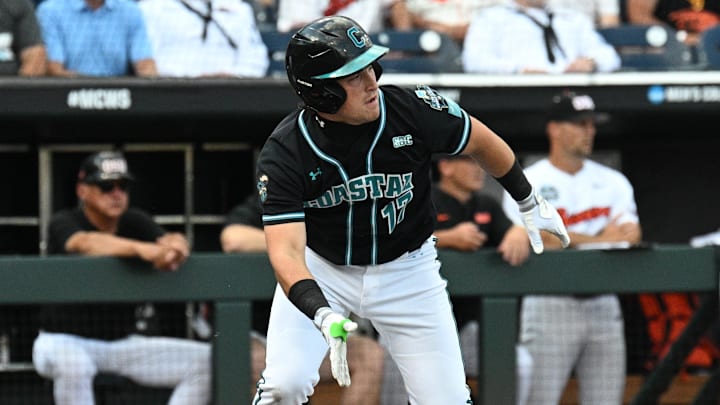 Jun 15, 2025; Omaha, Neb, USA;  Coastal Carolina Chanticleers catcher Caden Bodine (17) reaches on an infield error by the Oregon State Beavers during the first inning at Charles Schwab Field.