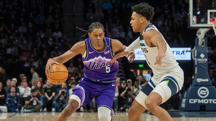 Mar 18, 2026; Minneapolis, Minnesota, USA; Utah Jazz forward Cody Williams (5) dribbles the ball as Minnesota Timberwolves guard Terrence Shannon Jr. (1) plays defense in the second half at Target Center. Mandatory Credit: Jesse Johnson-Imagn Images