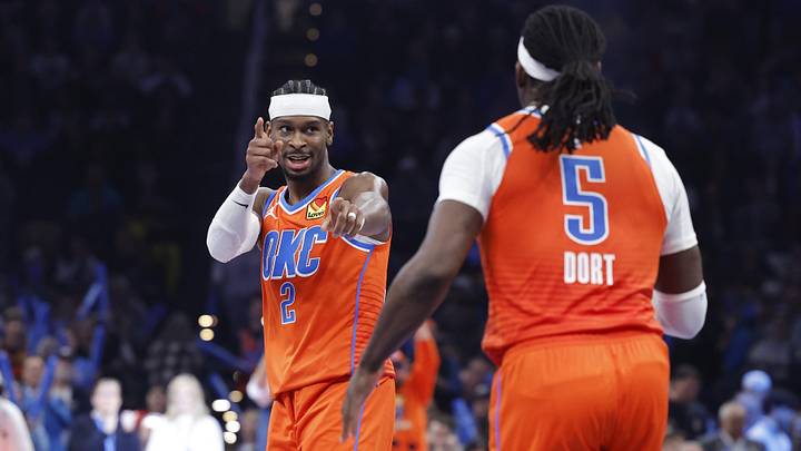 Nov 28, 2025; Oklahoma City, Oklahoma, USA; Oklahoma City Thunder guard Shai Gilgeous-Alexander (2) gestures towards guard Luguentz Dort (5) after a basket against the Phoenix Suns during the second half at Paycom Center. Mandatory Credit: Alonzo Adams-Imagn Images