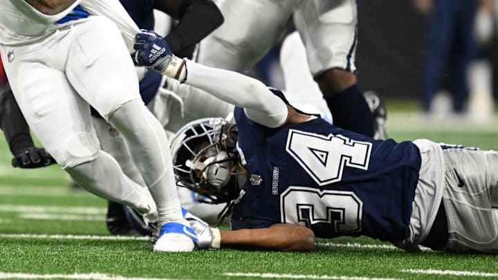 Dec 4, 2025; Detroit, Michigan, USA; Detroit Lions running back David Montgomery (5) runs against Dallas Cowboys cornerback Shavon Revel Jr. (34) and safety Donovan Wilson (6) during the first half at Ford Field. Mandatory Credit: Lon Horwedel-Imagn Images