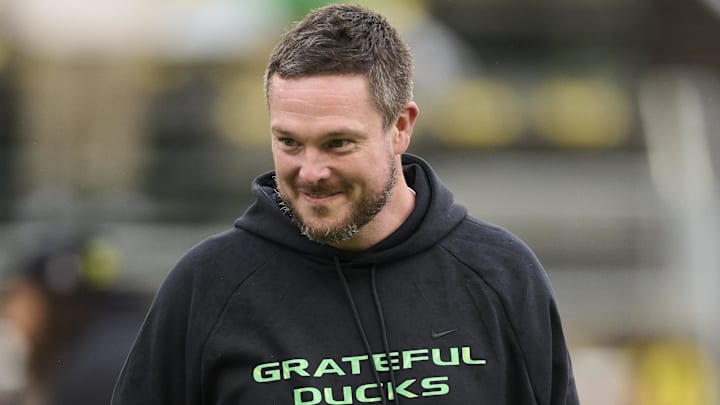 Oct 25, 2025; Eugene, Oregon, USA; Oregon Ducks head coach Dan Lanning encourages players during warm ups before a game against the Wisconsin Badgers at Autzen Stadium. The Ducks are wearing uniforms celebrating the Grateful Dead. Mandatory Credit: Troy Wayrynen-Imagn Images