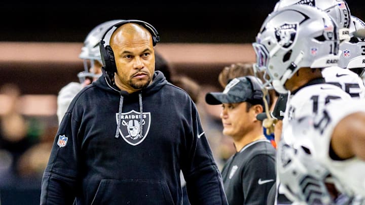Las Vegas Raiders coach Antonio Pierce looks at his team on the sidelines.