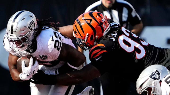 Cincinnati Bengals defensive tackle McKinnley Jackson (93) tackles Las Vegas Raiders running back Alexander Mattison (22) in the 3rd quarter at Paycor Stadium Sunday, November 3, 2024.