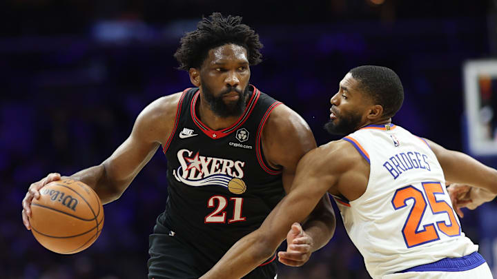 Jan 24, 2026; Philadelphia, Pennsylvania, USA; Philadelphia 76ers center Joel Embiid (21) drives against New York Knicks guard Mikal Bridges (25) during the third quarter at Xfinity Mobile Arena. Mandatory Credit: Bill Streicher-Imagn Images