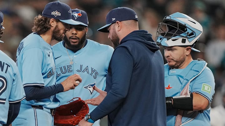Oct 17, 2025; Seattle, Washington, USA; Toronto Blue Jays manager John Schneider (14) takes the ball from pitcher Kevin Gausman (34) in the sixth inning during game five of the ALCS round against the Seattle Mariners for the 2025 MLB playoffs at T-Mobile Park. Mandatory Credit: Stephen Brashear-Imagn Images Oct 17, 2025; Seattle, Washington, USA; Toronto Blue Jays manager John Schneider (14) takes the ball from pitcher Kevin Gausman (34) in the sixth inning during game five of the ALCS round against the Seattle Mariners for the 2025 MLB playoffs at T-Mobile Park. Mandatory Credit: Stephen Brashear-Imagn Images