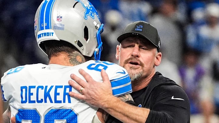 Detroit Lions head coach Dan Campbell hugs offensive tackle Taylor Decker (68) during warmup 