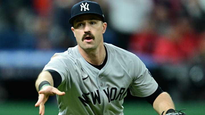 Oct 17, 2024; Cleveland, Ohio, USA; New York Yankees third baseman Jon Berti (19) tosses to first during the sixth inning against the Cleveland Guardians in game 3 of the American League Championship Series at Progressive Field