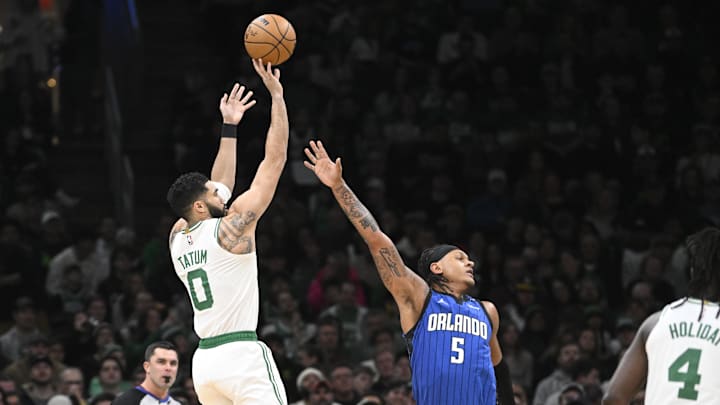 Boston Celtics forward Jayson Tatum (0) shoots over Orlando Magic forward Paolo Banchero (5) during the first half at TD Garden. Boston Celtics forward Jayson Tatum (0) shoots over Orlando Magic forward Paolo Banchero (5) during the first half at TD Garden.