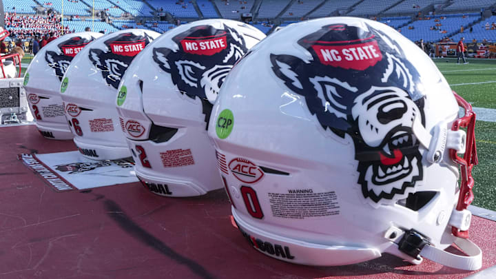 Sep 7, 2024; Charlotte, North Carolina, USA; North Carolina State Wolfpack helmets during pregame activity for the Dukes Mayo Classic against the Tennessee Volunteers at Bank of America Stadium. Mandatory Credit: Jim Dedmon-Imagn Images Sep 7, 2024; Charlotte, North Carolina, USA; North Carolina State Wolfpack helmets during pregame activity for the Dukes Mayo Classic against the Tennessee Volunteers at Bank of America Stadium. Mandatory Credit: Jim Dedmon-Imagn Images