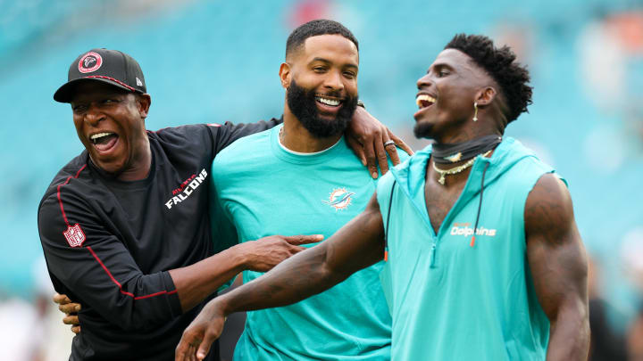 Aug 9, 2024; Miami Gardens, Florida, USA; Atlanta Falcons head coach Raheem Morris greets Miami Dolphins wide receiver Odell Beckham Jr. (3) and wide receiver Tyreek Hill (10) during warmups for a preseason game at Hard Rock Stadium. Mandatory Credit: Nathan Ray Seebeck-USA TODAY Sports