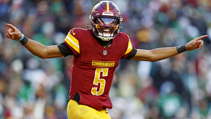 Dec 22, 2024; Landover, Maryland, USA; Washington Commanders quarterback Jayden Daniels (5) celebrates after throwing a touchdown during the fourth quarter against the Philadelphia Eagles at Northwest Stadium. Mandatory Credit: Peter Casey-Imagn Images