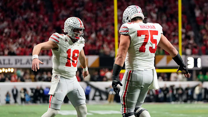 Ohio State Buckeyes quarterback Will Howard (18) celebrates a touchdown with offensive lineman Carson Hinzman (75) against Notre Dame Fighting Irish in the second quarter during the College Football Playoff National Championship at Mercedes-Benz Stadium in Atlanta on January 20, 2025. Ohio State Buckeyes quarterback Will Howard (18) celebrates a touchdown with offensive lineman Carson Hinzman (75) against Notre Dame Fighting Irish in the second quarter during the College Football Playoff National Championship at Mercedes-Benz Stadium in Atlanta on January 20, 2025.