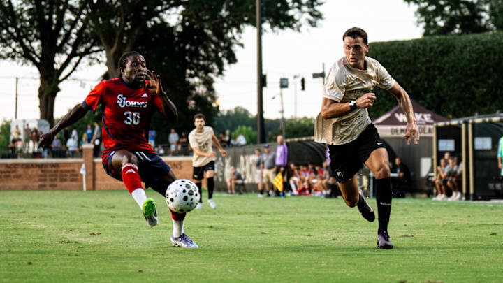 Wake Forest's Harvey Sarajian (10) goes for a ball along the left wing of the pitch, attempting to get past St. John's Godwin Partey (30).