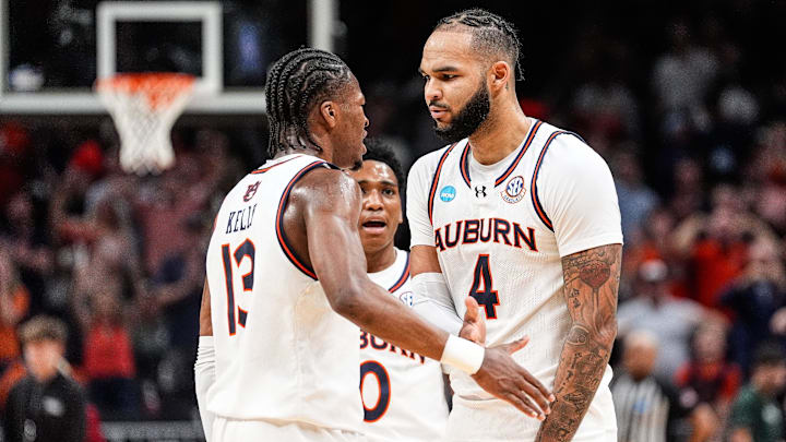 Auburn forward Johni Broome (4) celebrates a play against Michigan State with guard Miles Kelly (13), left, and guard Tahaad Pettiford (0), center, during the first half of the Elite Eight round of NCAA tournament at State Farm Arena in Atlanta, Ga. on Sunday, March 30, 2025.