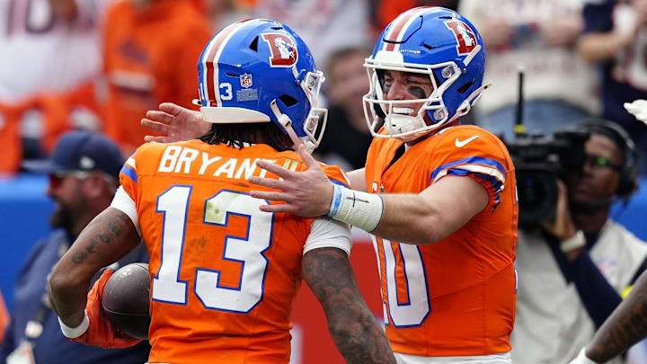Oct 26, 2025; Denver, Colorado, USA; Denver Broncos wide receiver Pat Bryant (13) celebrates with quarterback Bo Nix (10) after scoring a touchdown against the Dallas Cowboys in the first half at Empower Field at Mile High. 