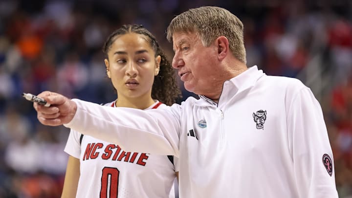 Mar 9, 2025; Greensboro, NC, USA;  NC State Wolfpack head coach Wes Moore talks with NC State Wolfpack guard Devyn Quigley (0) during the fourth quarter against Duke Blue Devils at First Horizon Coliseum. Mandatory Credit: Cory Knowlton-Imagn Images