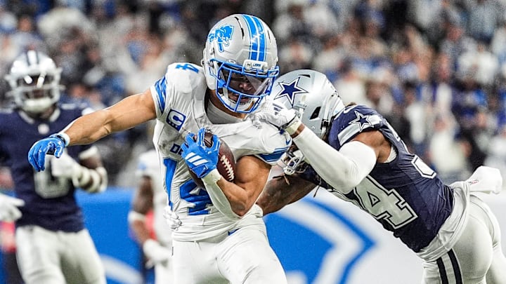 Detroit Lions wide receiver Amon-Ra St. Brown (14) makes a catch against Dallas Cowboys cornerback Shavon Revel Jr. (34) 